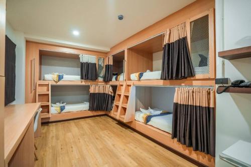 a room with bunk beds in a house at Phuket Airport Place - SHA Plus in Nai Yang Beach