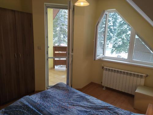 a bedroom with a bed and a large window at BOROVETS Royal Plaza - A405 in Borovets