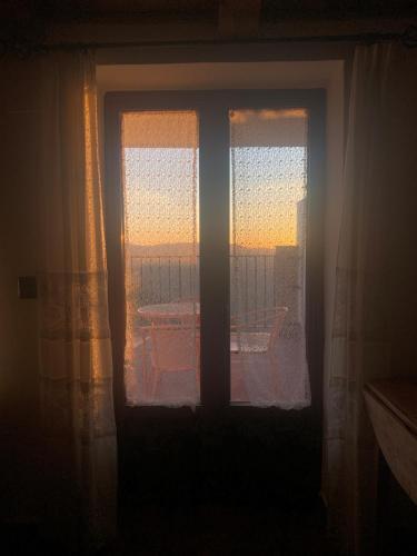 a window in a room with a view of the sunset at Apartamentos Rurales Peralta in Segura de la Sierra