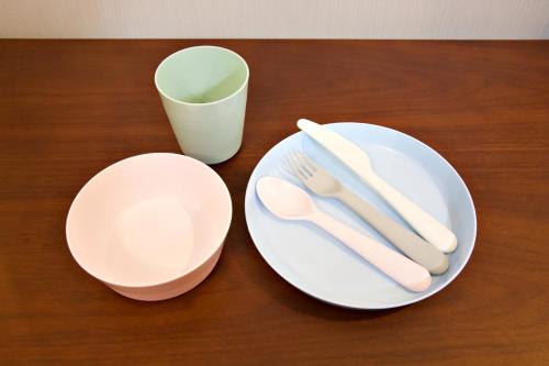 a table with two plates and a cup and a fork and knife at オーシャンテラス瀬底 Room202 in Motobu