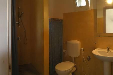 a bathroom with a toilet and a shower and a sink at Le casette di Marilena Agave Iucca in Pantelleria