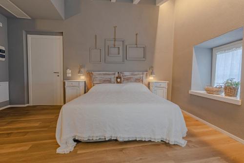 a bedroom with a bed with a white bedspread at Il cantuccio sul Garda - Relais di charme in Cavaion Veronese