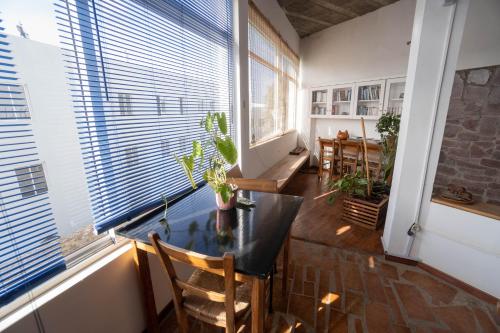 a room with a table and chairs and a window at Residencial Che Guevara B & B Stop over in Mindelo