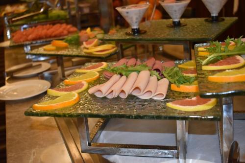 a bunch of different types of food on a table at Grand Millennium Tabuk in Tabuk