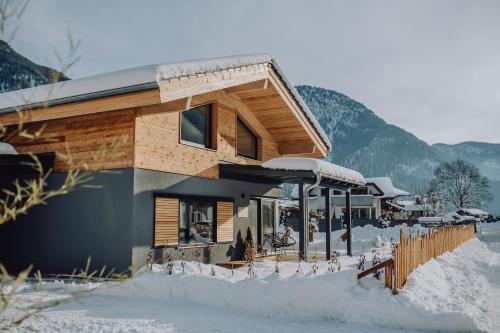 a building with snow on the ground in front of it at Haus Wildmoos in Sankt Martin bei Lofer