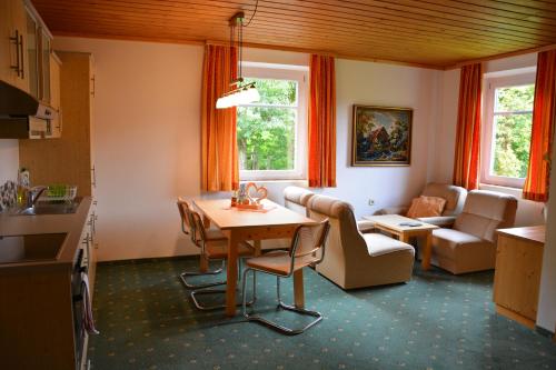 a kitchen and living room with a table and chairs at Appart Sölkhof in Schöder