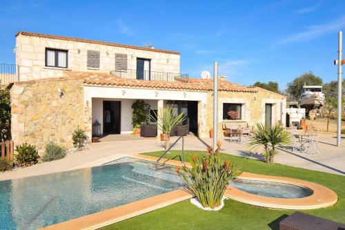 a house with a swimming pool in front of it at Agroturisme Es Racó De Maria in Maria de la Salut