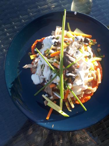 a blue plate of food on a table at Maison Du Cheval in Chalais