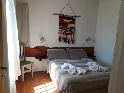 a bedroom with a bed with towels on it at Crisol 21 in Huerta Grande