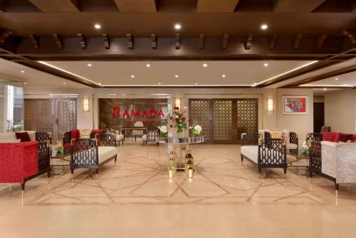 a banquet hall with chairs and a table with flowers at Ramada by Wyndham Lahore Gulberg II in Lahore