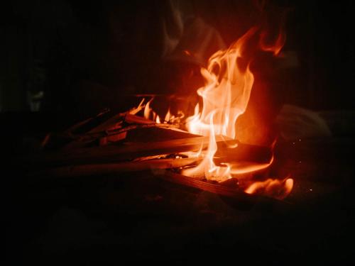 a fire is burning in a dark room at Ałabajka in Wleń