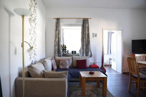 a living room with a couch and a table at Apartment Gartenstrasse 3 in Ostseebad Sellin