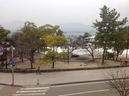 a person walking down a street in a park at Yamaichi Bekkan in Miyajima