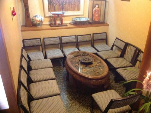 a group of chairs and a table in a room at Yamaichi Bekkan in Miyajima
