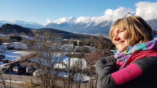a woman standing on top of a snow covered mountain at Gschwendtalm Tirol - Luxus-Apartment für Ihre Auszeit in Tulfes