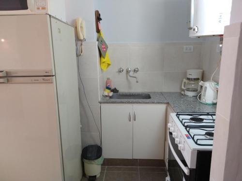a small kitchen with a sink and a stove at Monoambiente PLENO centro in Mar del Plata
