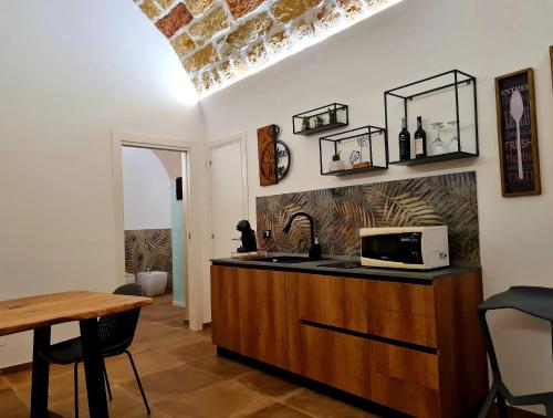 uma cozinha com um lavatório e um micro-ondas no balcão em SCRUSCIU HOME em Terrasini