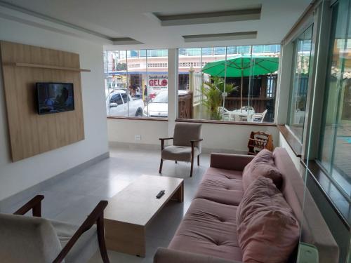a living room with a couch and a coffee table at Pousada Espirito do Mar in Cabo Frio