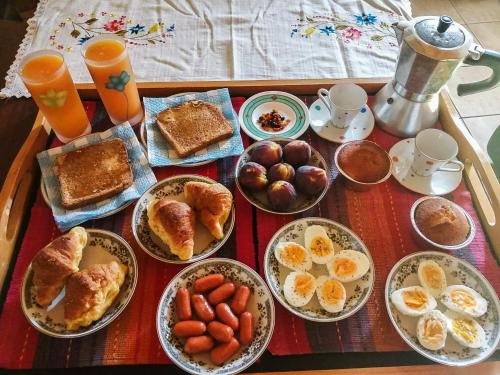 a table topped with plates of breakfast foods and oranges at Megris Country Houses in Vingláfia