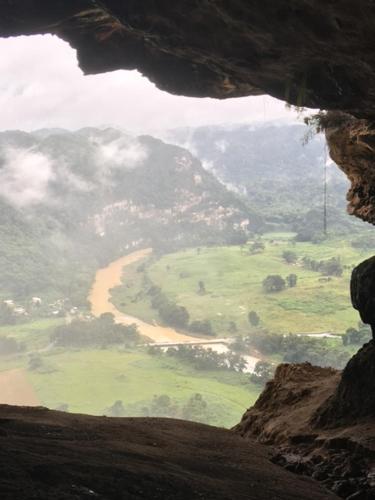 a view from the inside of a cave looking down at a valley at Casa de Campo Rio Arriba in Arecibo