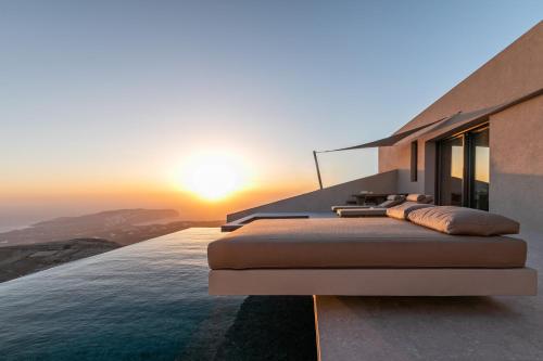 a view of the ocean from a house at Santorini Sky, Luxury Resort in Pirgos