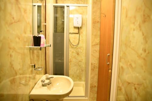 a bathroom with a sink and a shower at The Maycliffe Hotel in Torquay