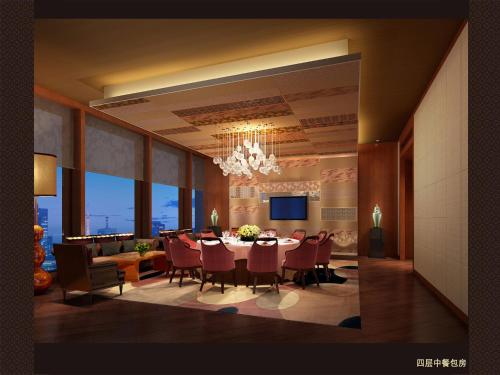 a dining room with a table and chairs and a television at Grand Skylight International Hotel Ganzhou Chang Zhen Avenue in Ganzhou