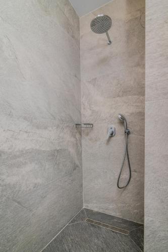 a shower with a shower head in a bathroom at Nikolakos Villa in Agios Nikolaos