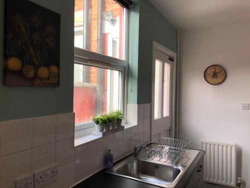 a kitchen with a sink and a window at Coventry Cosy House, City Centre, Free Parking, Sleeps 5, by EMPOWER HOMES in Coventry