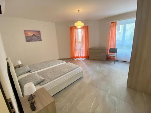 a bedroom with a bed and a table and a window at Appartamento Lungolago in Locarno