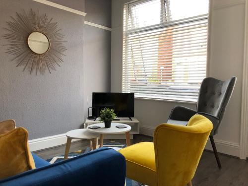 a living room with two chairs and a table at Coventry Cosy House, City Centre, Free Parking, Sleeps 5, by EMPOWER HOMES in Coventry