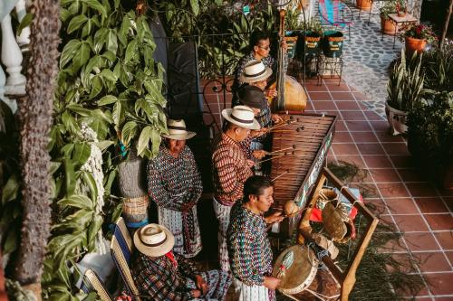 a group of men in hats standing in a garden at Hotel La Casa del Mundo in Jaibalito