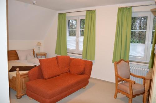 a living room with a couch and a bed at Hotel Holter Schloßkrug in Schloß Holte-Stukenbrock