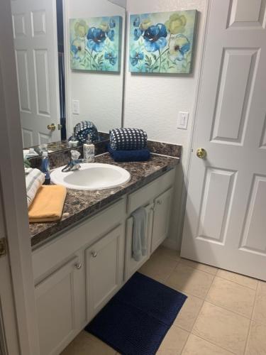 a bathroom with a sink and a mirror at Orlando Vacation Villa in Orlando