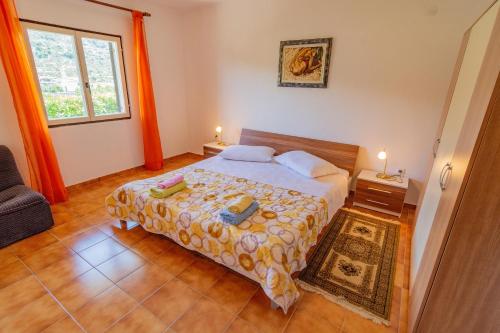 a bedroom with a bed and a window at Apartment Dumičić 1 in Rab