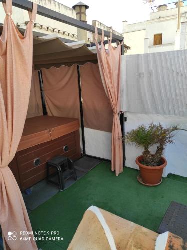 a tent with a bed and a desk and a plant at La Casa Del Recreo in Cómpeta