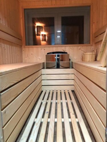 a sauna with wood paneling and a window at LUXURY VILLA M NEAR 2km AWAY FROM BITOLA WITH PRIVATE SWIMMING POOL & SAUNA &JACUZZI in Bitola