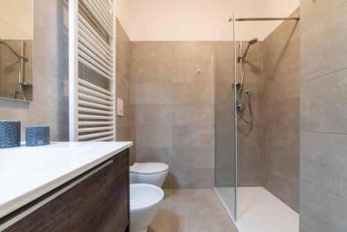 a bathroom with a toilet and a glass shower at Casa Pinù in Bologna