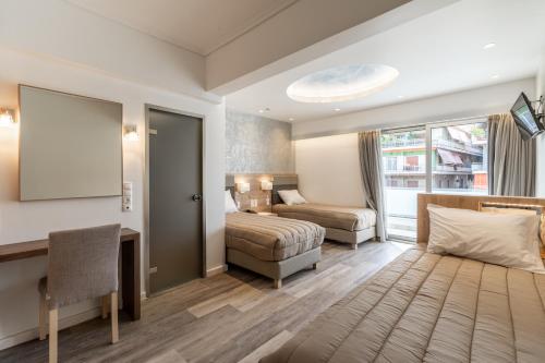 a hotel room with a bed and a desk at Xenophon Hotel in Athens