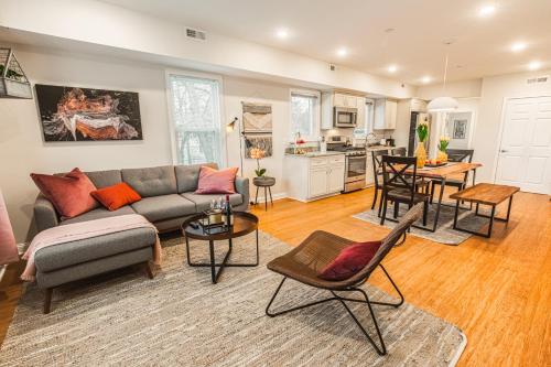 a living room with a couch and a table at The Inn at Newton Highlands in Newton