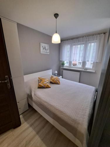 a bedroom with a bed with two pillows on it at Studio Zabobrze in Jelenia Góra