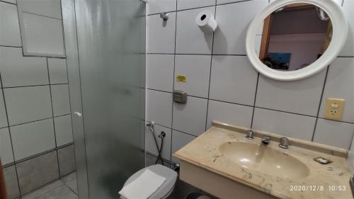 a bathroom with a sink and a toilet and a mirror at Pousada Ecomar in Florianópolis