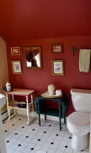 a bathroom with a toilet and a table with a cake on it at Modern Cottage Downtown NPT-Waites Wharf Cottage RE05618-STR in Newport