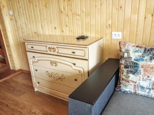 a dresser in a corner of a room with a couch at Садиба "У Валентини" in Yablunytsya