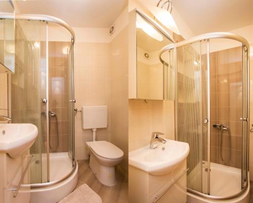 a bathroom with a shower and a toilet and a sink at Apartments Zonta 800 m From Beach in Rovinj