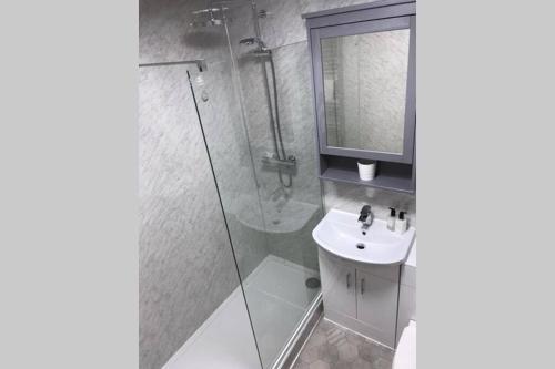 a bathroom with a shower and a sink at St Andrews Bungalow in Fife