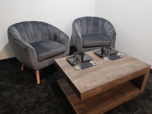 two chairs and a coffee table in a room at WooW Apartments in Velika Gorica