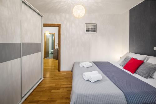 a bedroom with a large bed with two towels on it at Urban Premium Apartments in Poreč