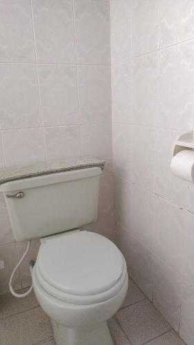 a bathroom with a white toilet in a room at Hotel Utama in Copacabana