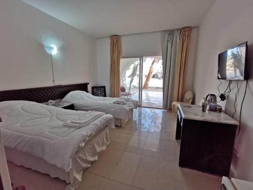 Säng eller sängar i ett rum på Azraq Rest House